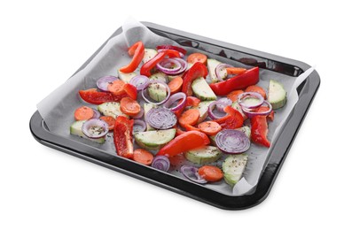 Photo of Baking pan with parchment paper and raw vegetables isolated on white
