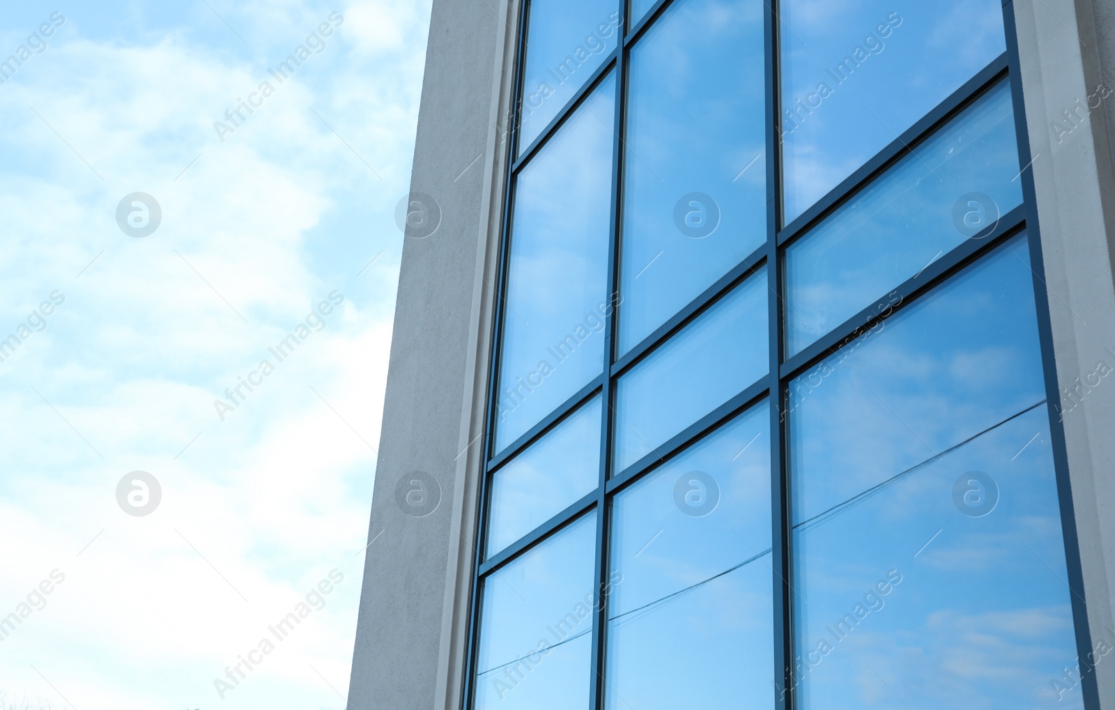 Photo of New modern building with tinted windows outdoors