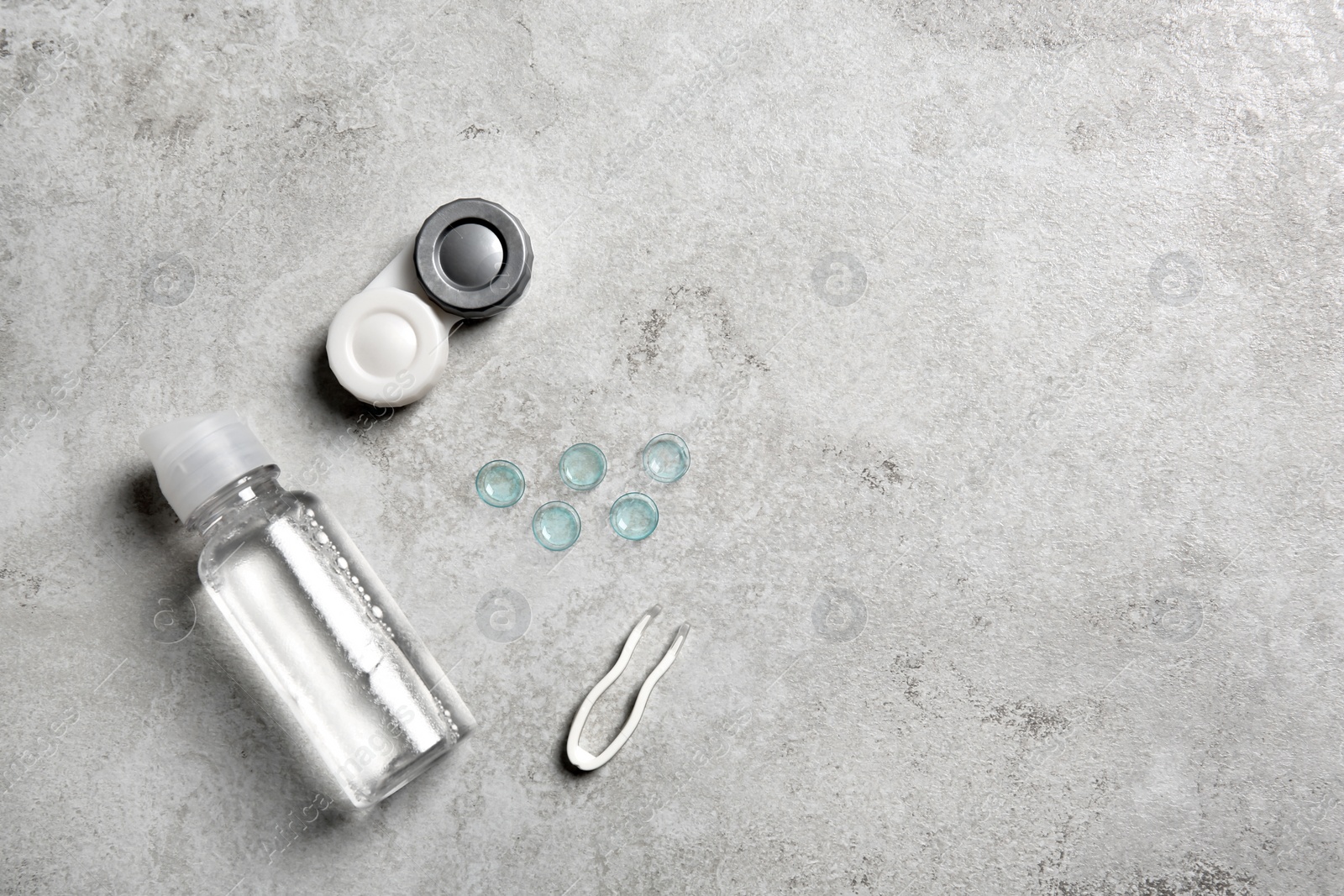 Photo of Contact lenses and accessories on light background, top view