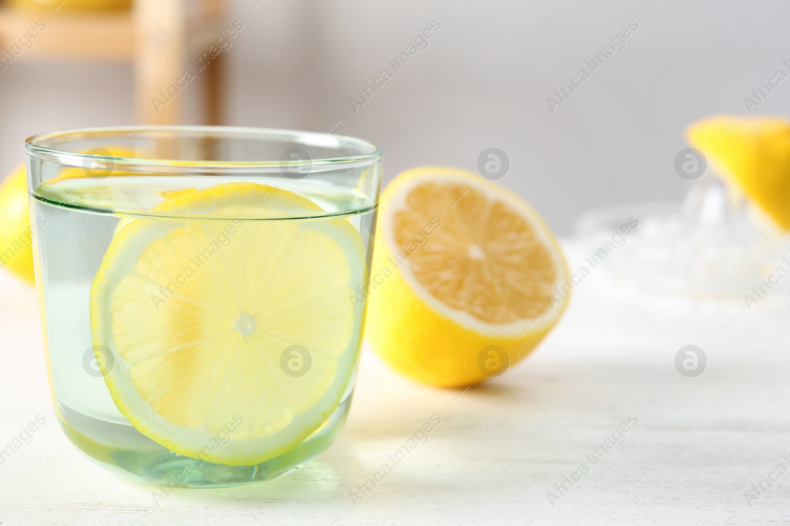 Photo of Glass of water with lemon slice on table
