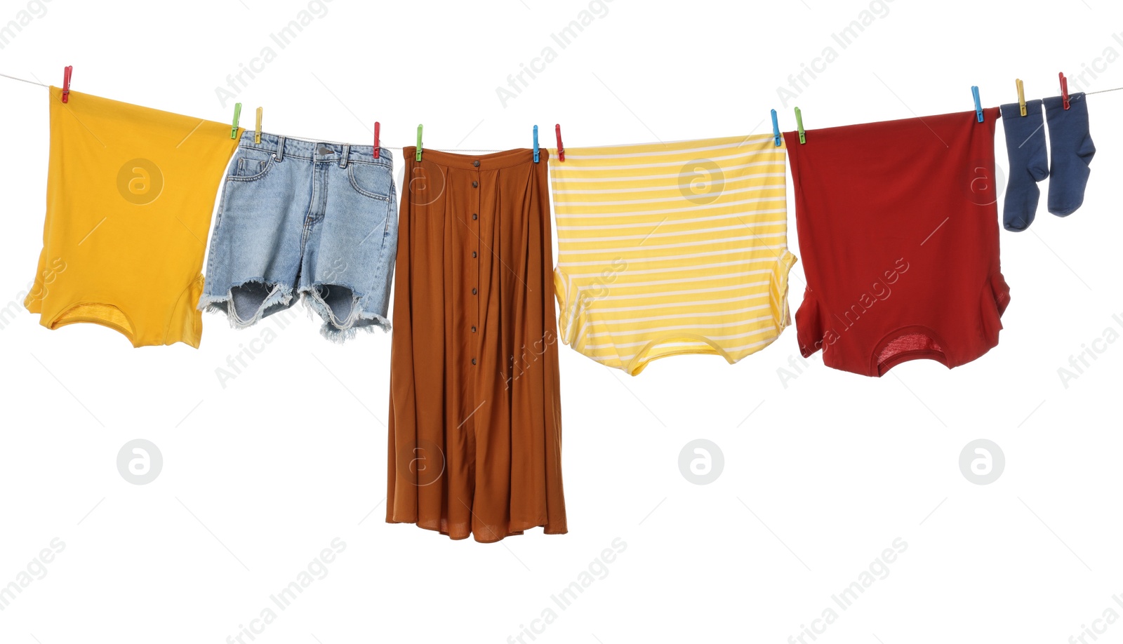 Photo of Different clothes drying on laundry line against white background