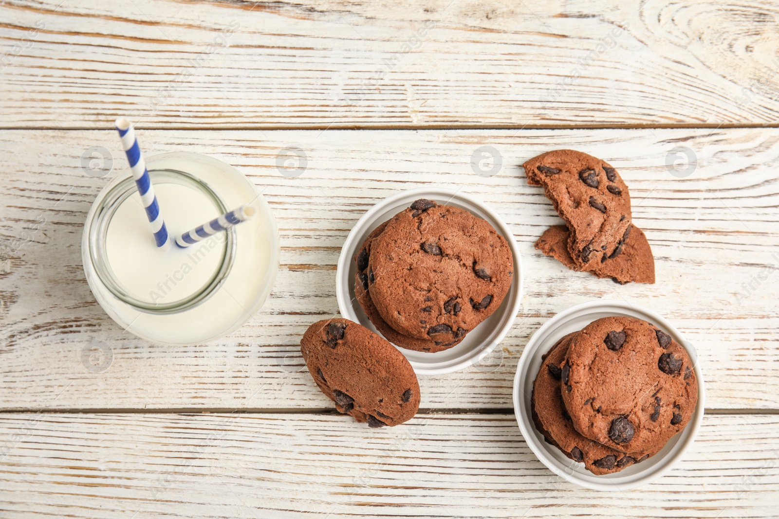 Photo of Flat lay composition with tasty chocolate chip cookies on wooden background