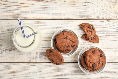 Photo of Flat lay composition with tasty chocolate chip cookies on wooden background