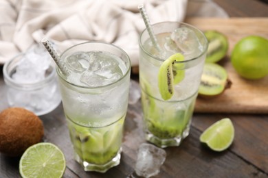Photo of Glasses of refreshing drink with kiwi on table, closeup