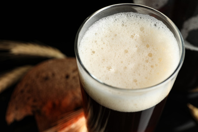 Glass of delicious kvass on dark background, closeup