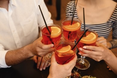 Photo of Friends with Aperol spritz cocktails resting together at restaurant, closeup