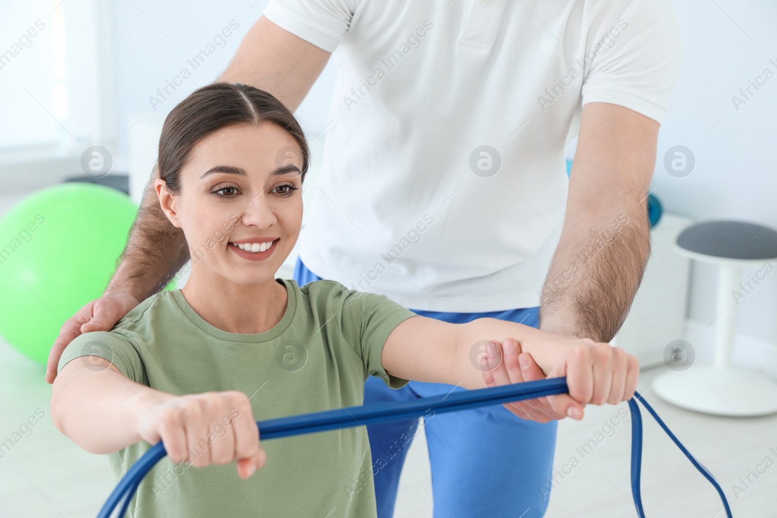 Photo of Professional physiotherapist working with female patient in rehabilitation center