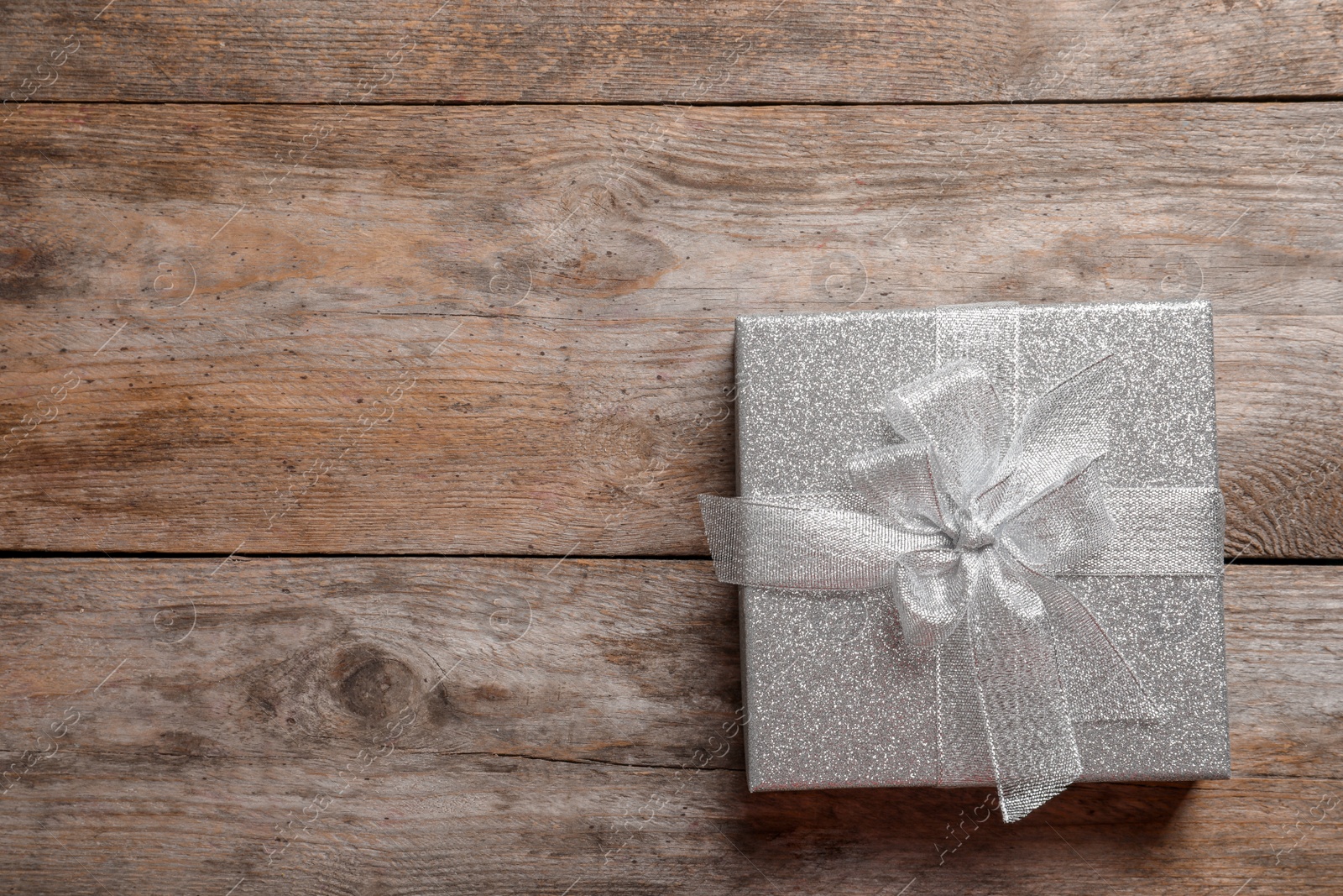 Photo of Beautiful gift box on wooden background, top view