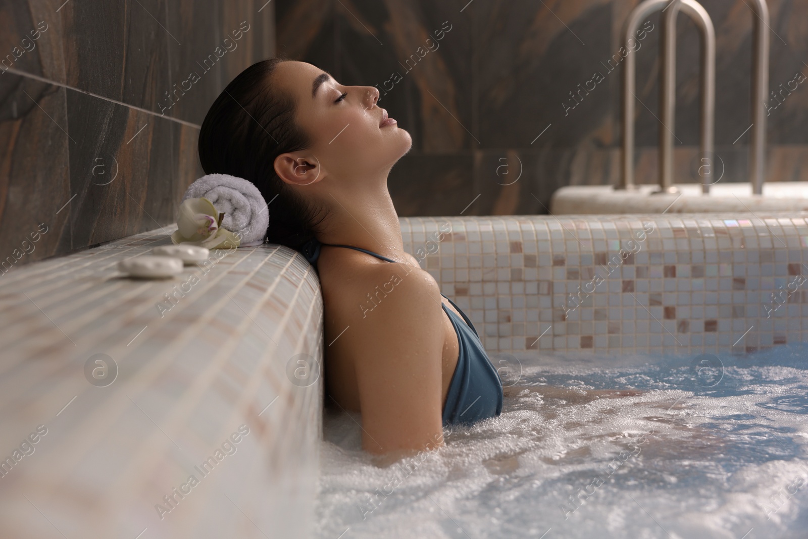 Photo of Beautiful woman relaxing in spa swimming pool, space for text