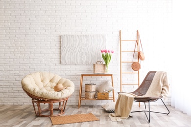 Photo of Stylish living room interior with cozy armchairs near brick wall