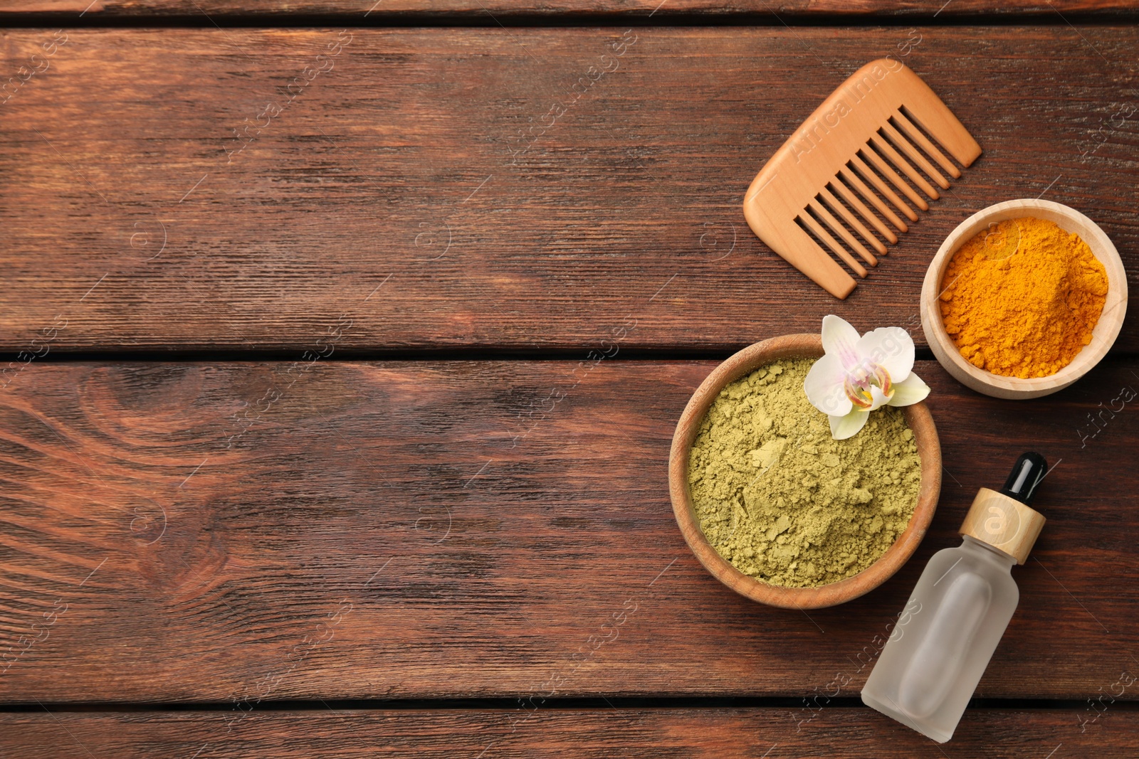 Photo of Flat lay composition with henna and turmeric powder on wooden table, space for text