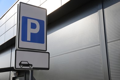 Traffic sign PARKING outdoors on sunny day