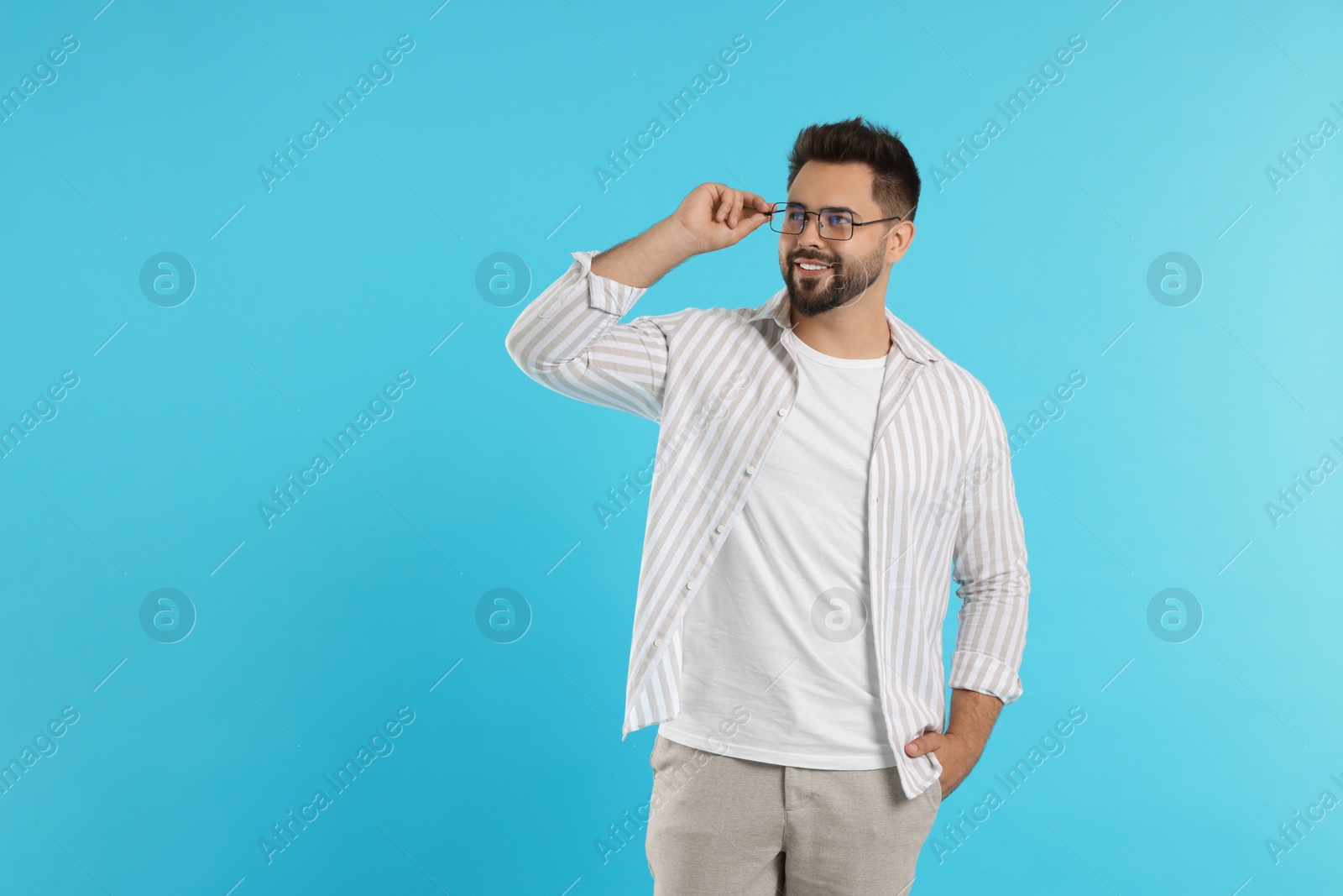 Photo of Handsome man wearing glasses on turquoise background, space for text