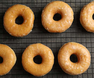 Photo of Delicious donuts on grey table, top view