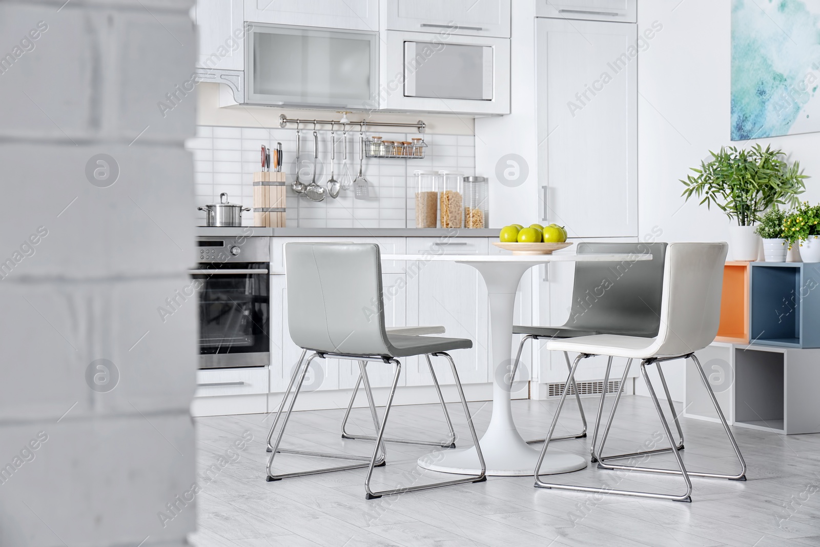 Photo of Stylish kitchen interior with dining table and chairs