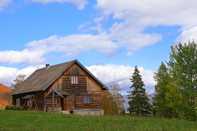 Beautiful wooden house and green trees in mountains