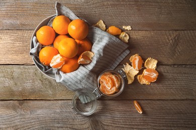 Photo of Many fresh ripe tangerines on wooden table, flat lay