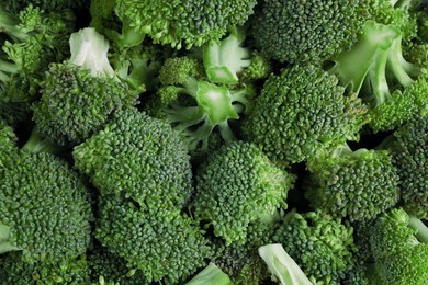 Photo of Fresh raw broccoli as background, top view