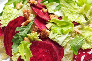 Photo of Delicious salad with beet as background, closeup