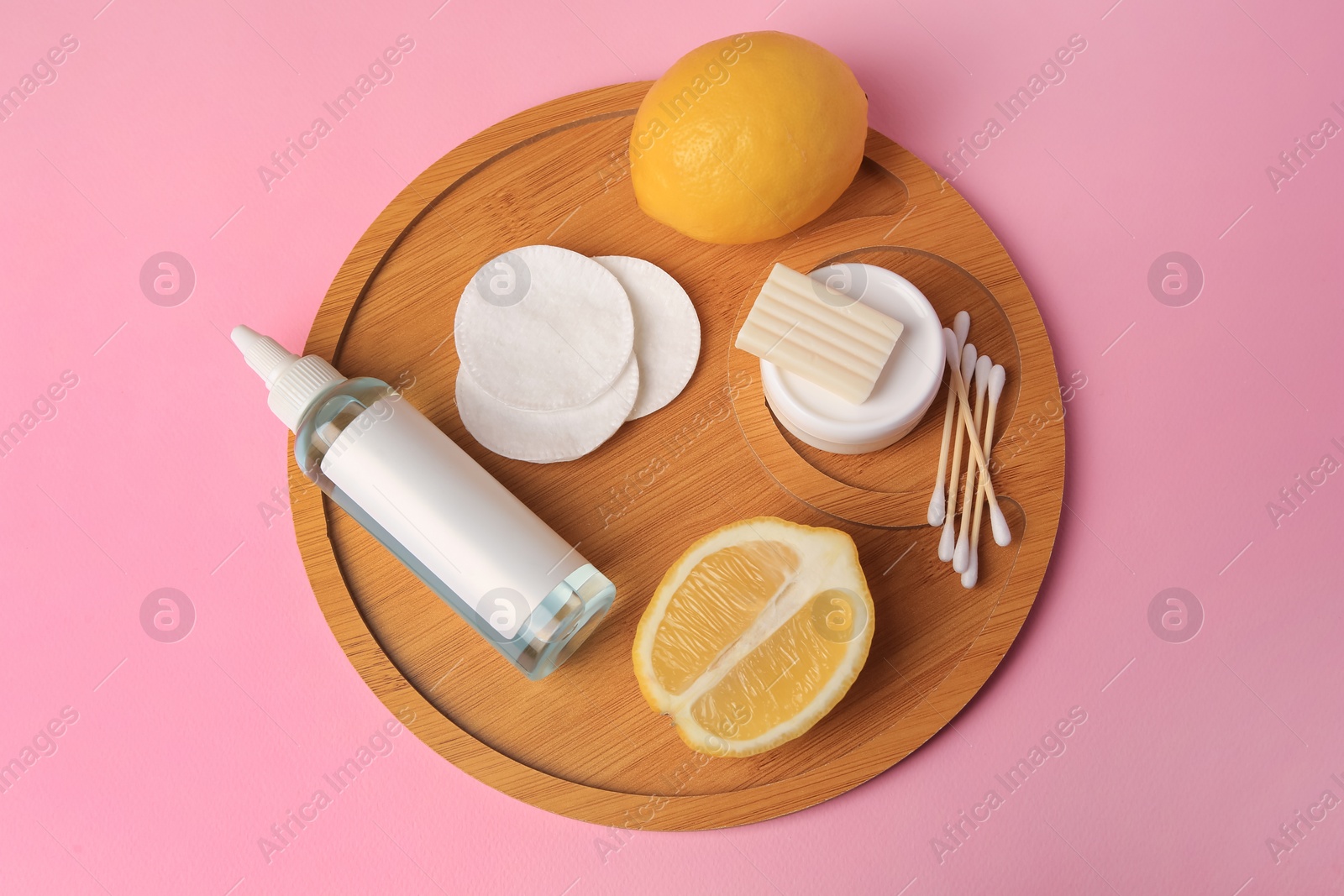 Photo of Lemon face cleanser. Fresh citrus fruits and personal care products on pink background, top view