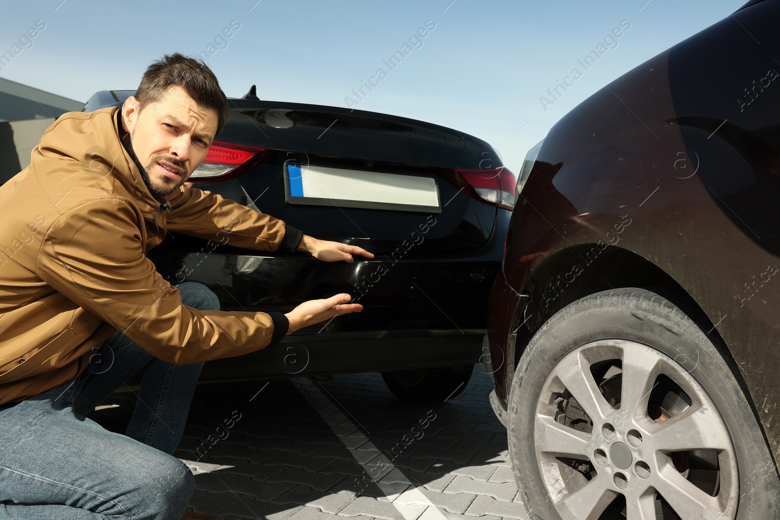 Photo of Stressed man near car with scratch outdoors. Auto accident