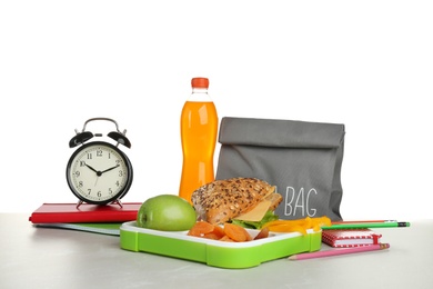 Photo of Composition with lunch box and food on table against white background