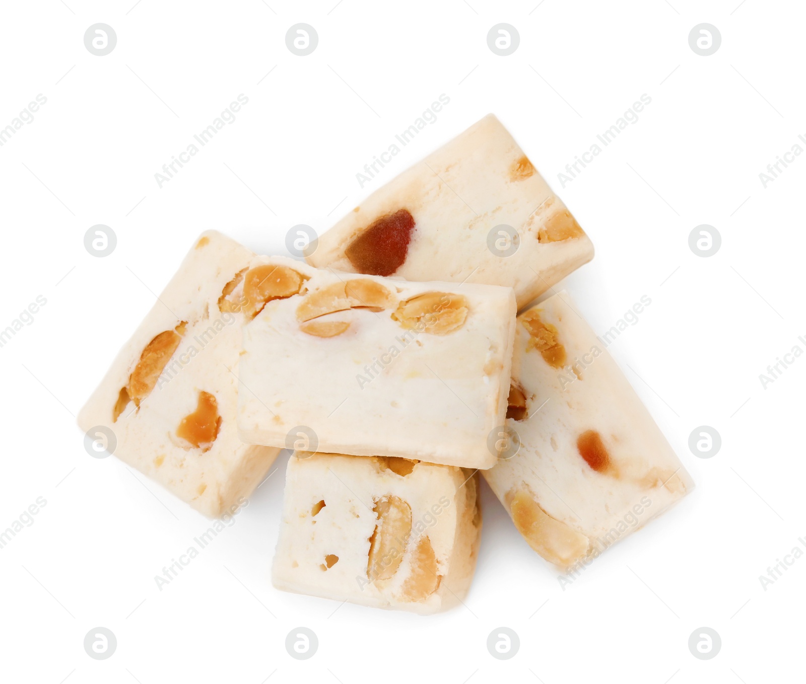 Photo of Many pieces of delicious nougat on white background, top view