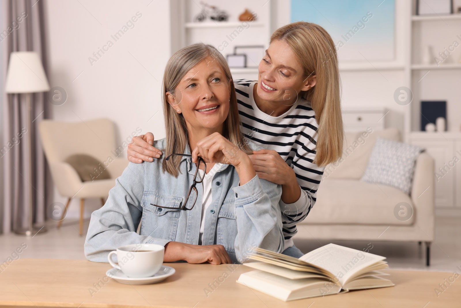 Photo of Happy mature mother and her daughter at home