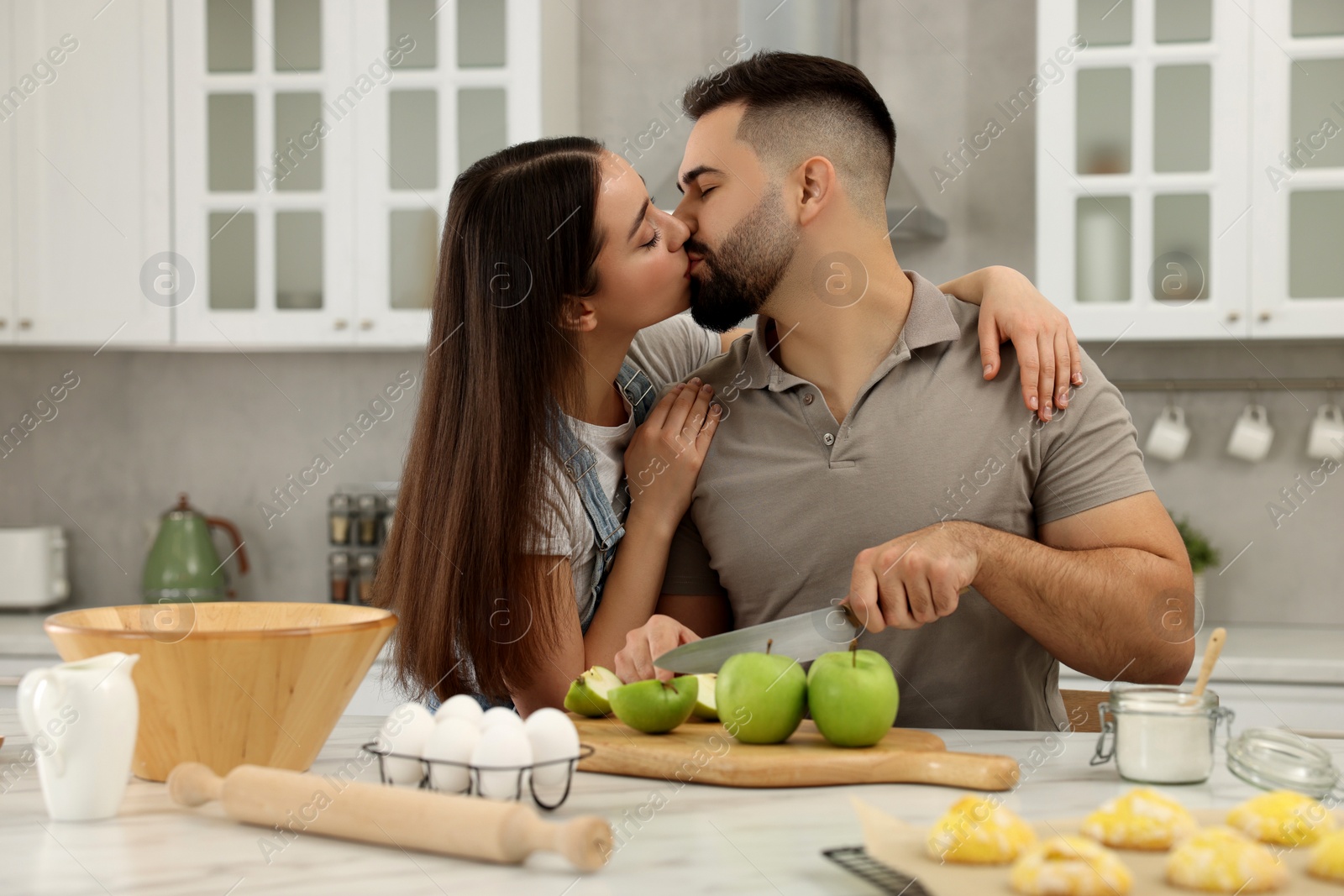 Photo of Happy young couple spending time together in kitchen