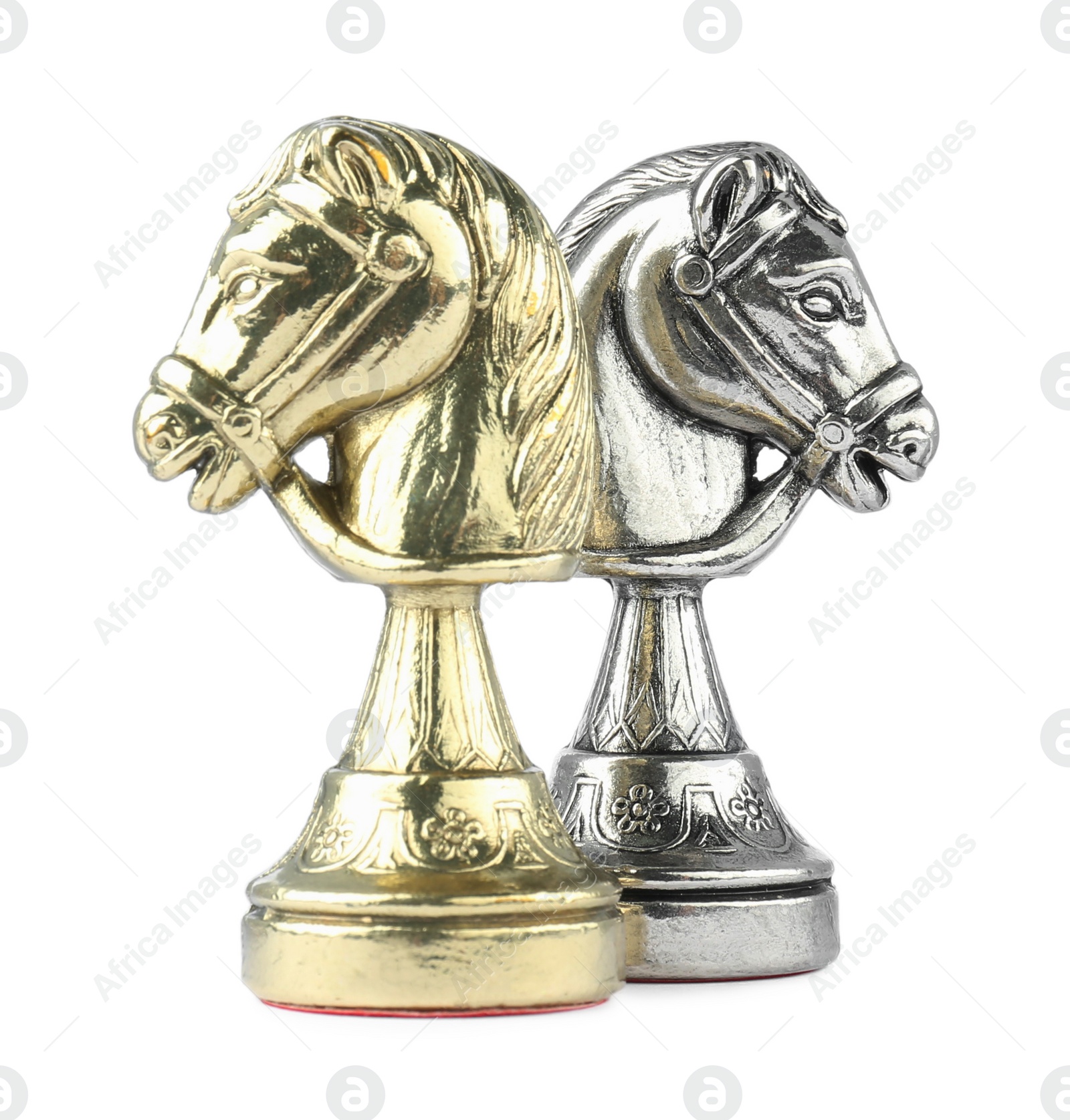 Photo of Silver and golden knights on white background. Chess pieces