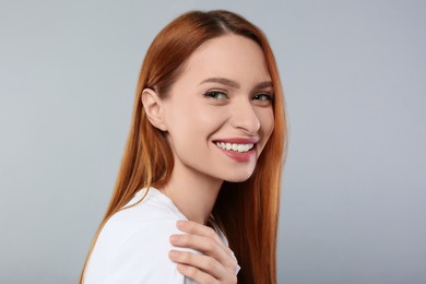 Photo of Portrait of beautiful young woman on light gray background