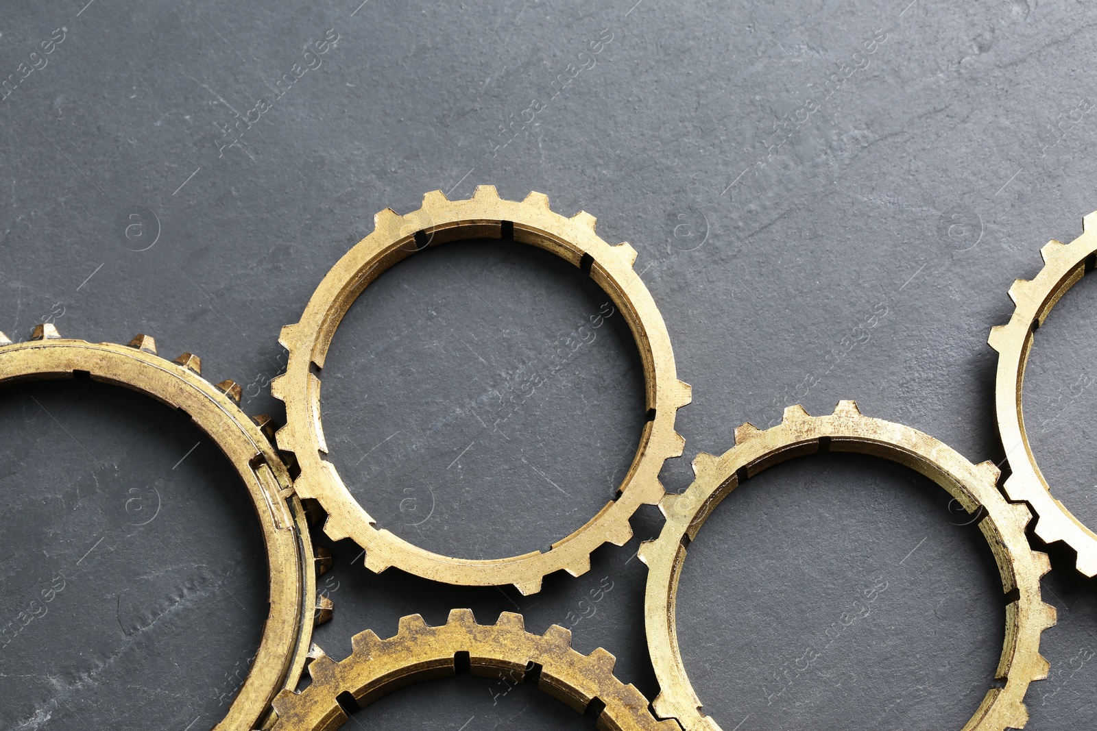 Photo of Stainless steel gears on grey background, flat lay