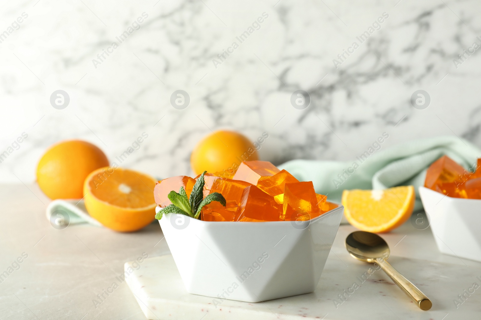 Photo of Composition with orange jelly in bowl on  table. Space for text