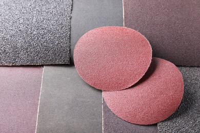 Many sheets of sandpaper as background, closeup