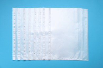 Punched pockets on light blue background, flat lay