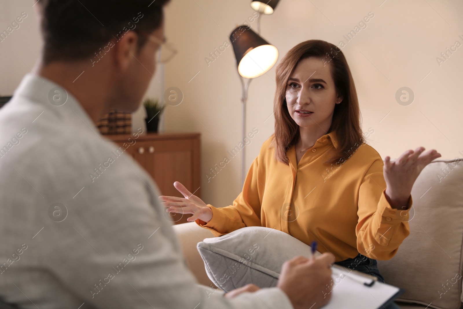 Photo of Professional psychotherapist working with patient in office