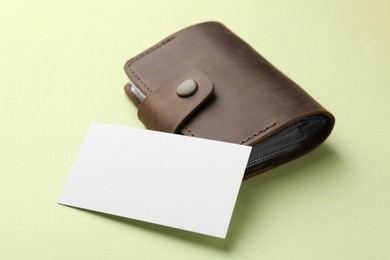 Leather business card holder with blank card on light green background