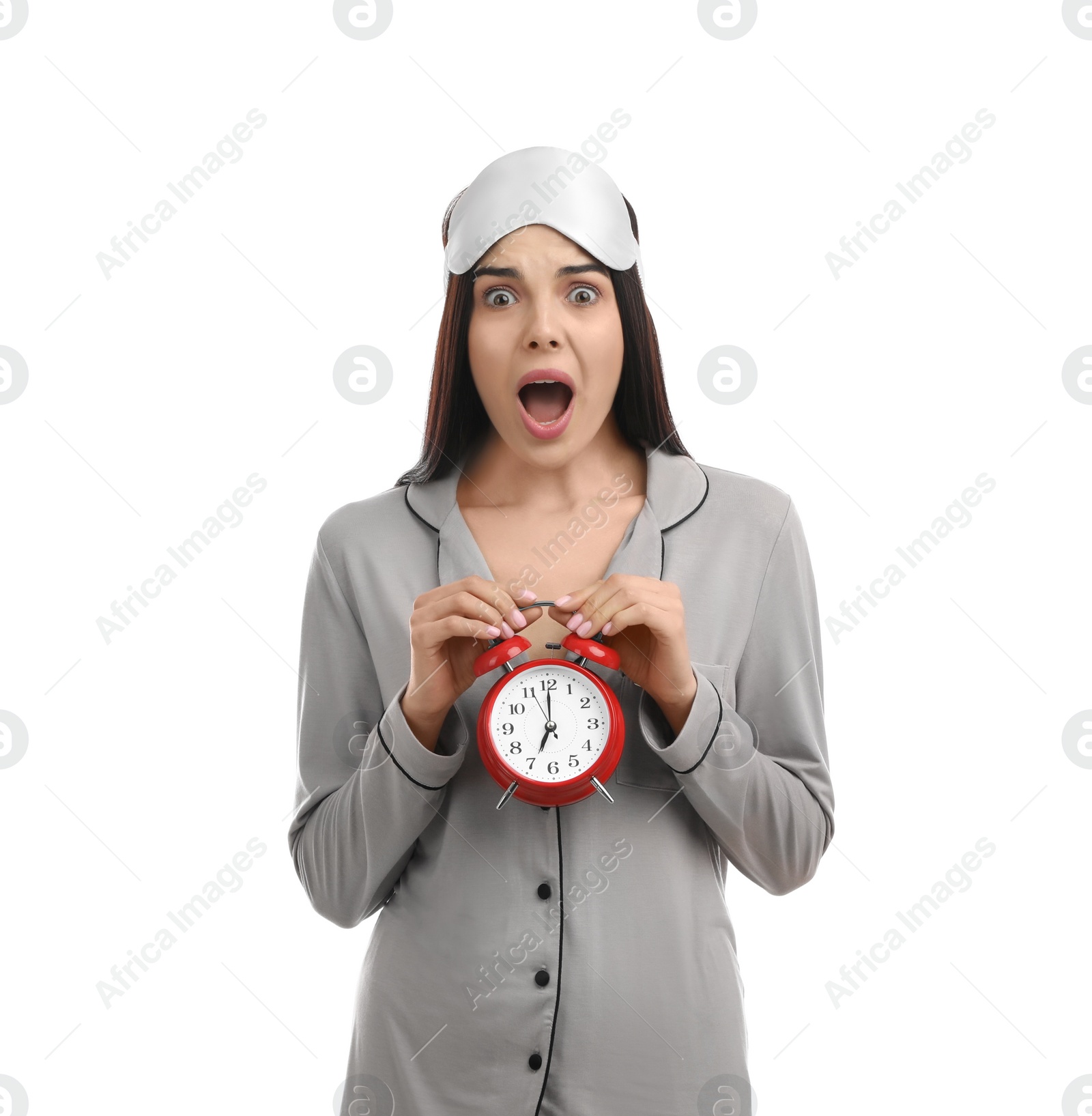 Photo of Emotional overslept woman with alarm clock on white background. Being late concept