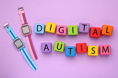 Photo of Phrase Digital Autism made of colorful cubes and smartwatches on violet background, flat lay. Addictive behavior