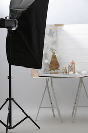 Christmas decor and double-sided backdrops on table in photo studio