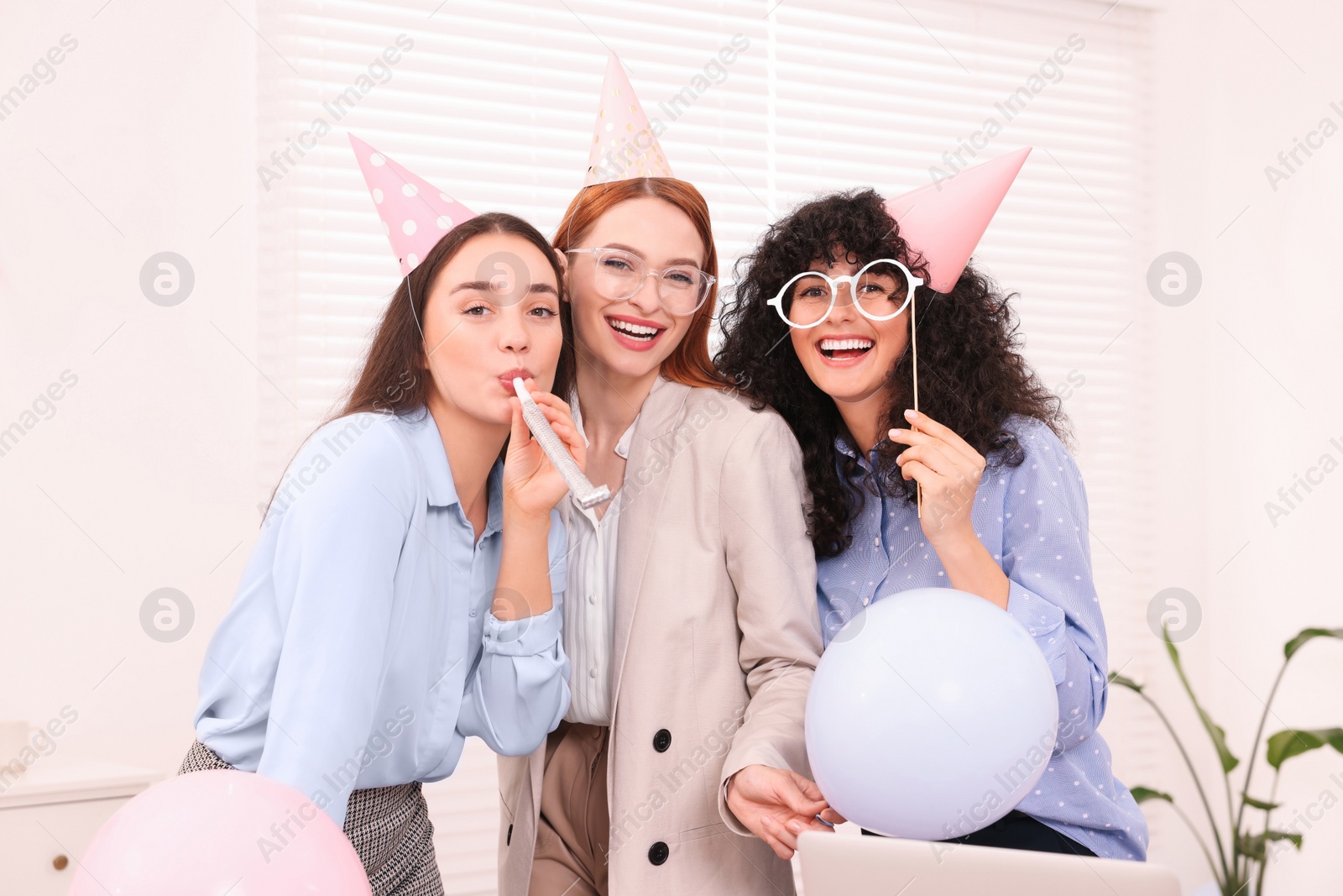 Photo of Coworkers having fun during office party indoors