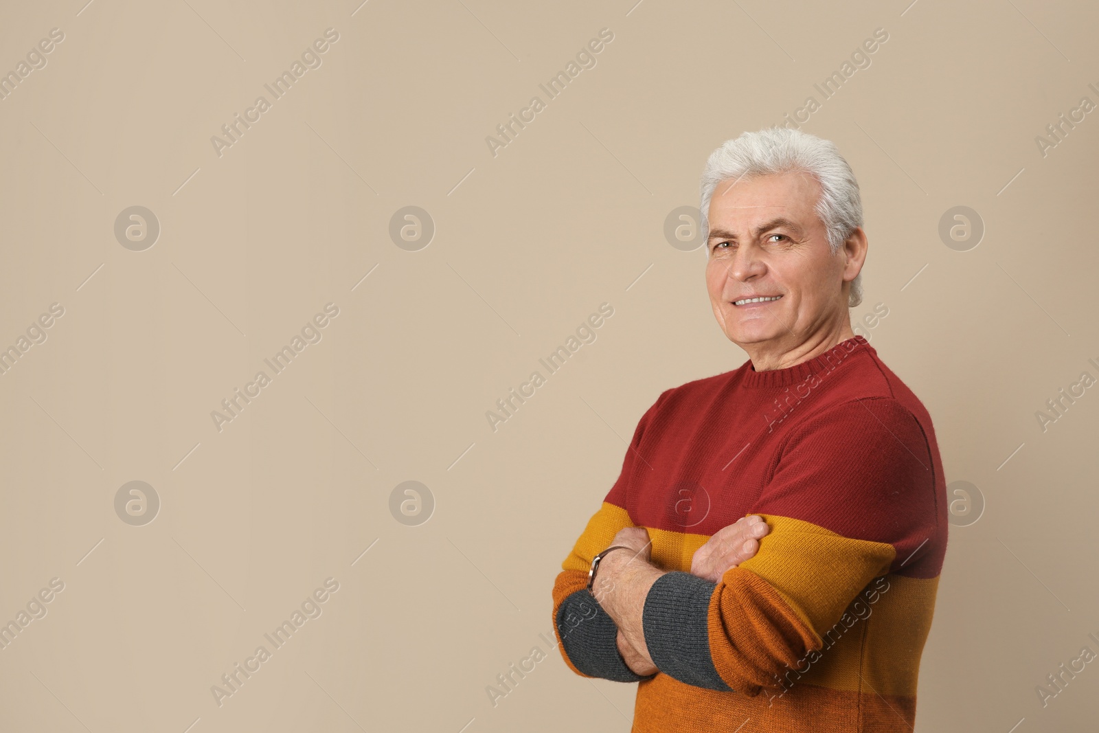 Photo of Portrait of handsome mature man on color background. Space for text