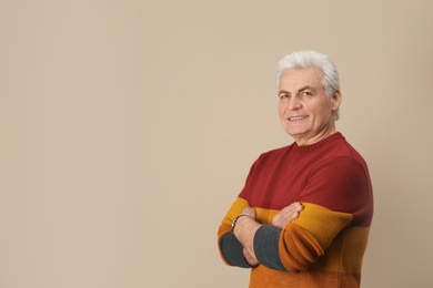 Photo of Portrait of handsome mature man on color background. Space for text