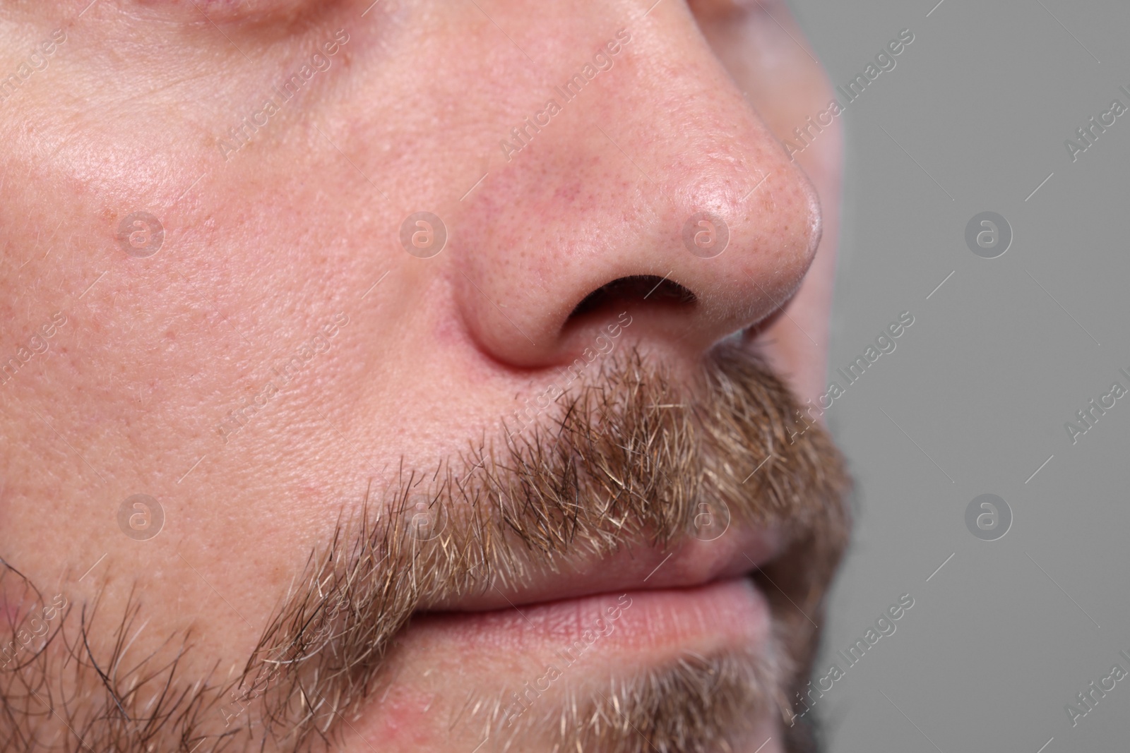 Photo of Closeup view of man with normal skin on grey background, space for text