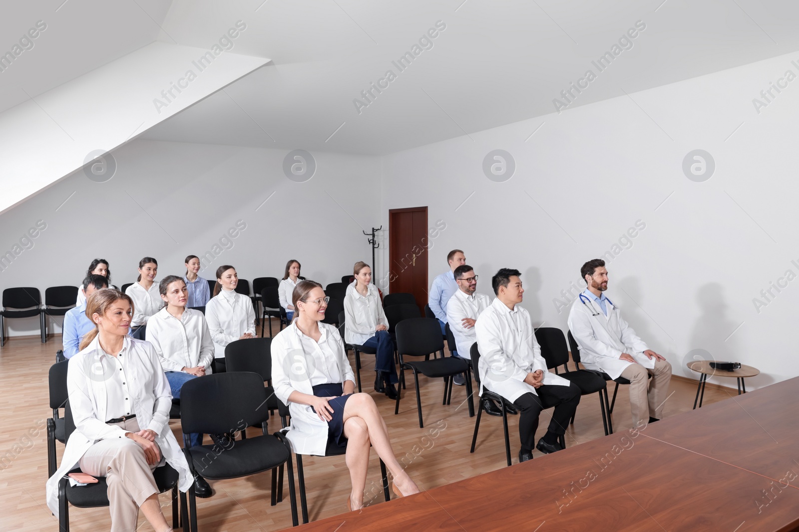 Photo of Team of doctors in meeting room during medical conference