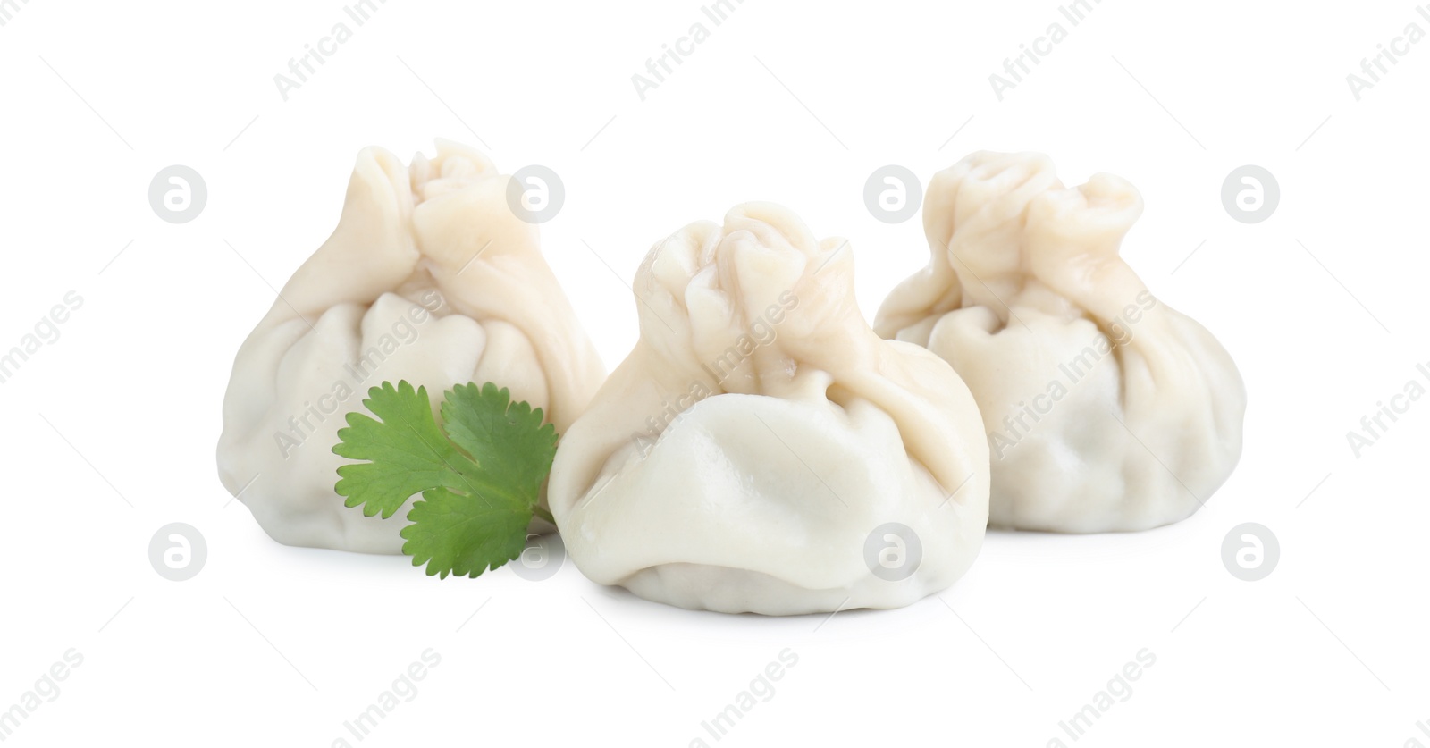 Photo of Three tasty khinkali (dumplings) and parsley isolated on white. Georgian cuisine