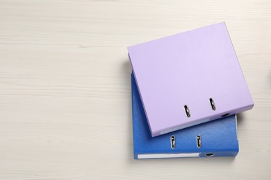 Photo of Office folders on white wooden table, flat lay. Space for text