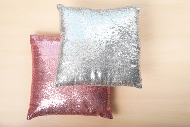 Photo of Soft decorative pillows on wooden background, top view