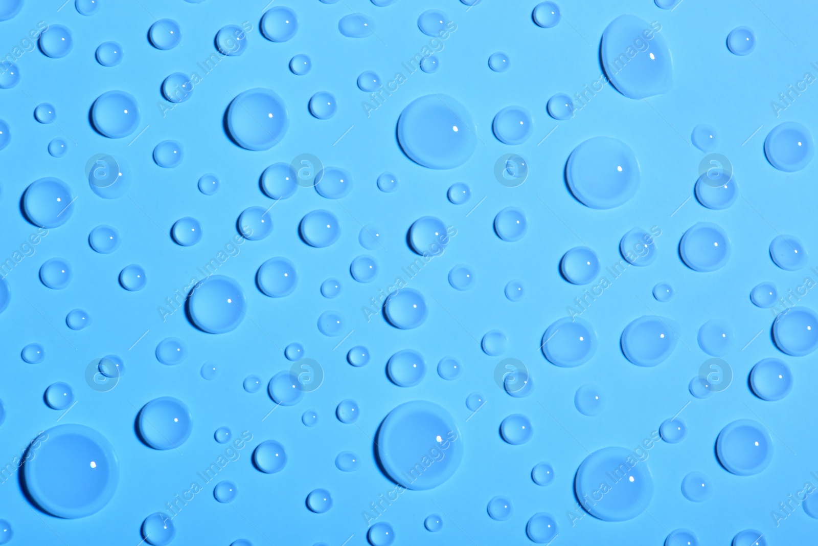 Photo of Water drops on color background, top view