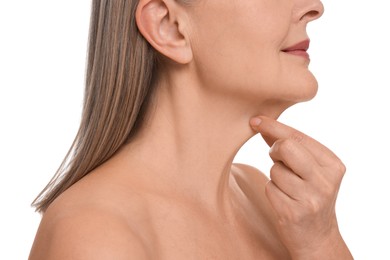 Photo of Mature woman touching her neck on white background, closeup